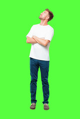 young blonde man smiling and looking upwards, towards the sky or to the spot where the publicist...