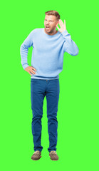 young blonde man paying attention, trying to hear and listen to what is being said, lending an ear.
