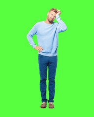young blonde man looking unenthusiastic and bored, listening to something dull and tedious and...