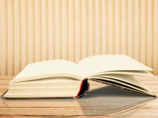 Open book on old wooden table at