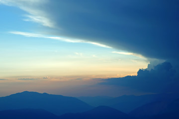 Fototapeta premium sunset in the clouds on a mountain background
