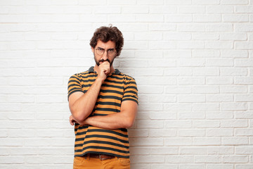 young dumb man Concentrating hard on an idea, with a serious far-off look, thinking with arm...