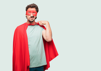 crazy man as a super hero with a stressed gesture, sweating and pulling shirt neck open, feeling...