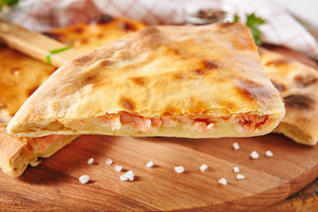 Fresh Baked Piece of Pie Stuffed with Salmon, Potato and Cheese Close Up with Selective Focus