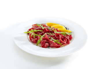 Dried Italian Beef Bresaola with Lemon and Greens Isolated