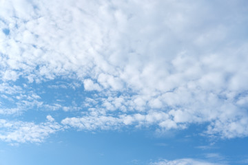 white fluffy clouds on blue sky background
