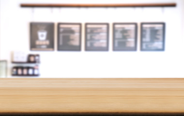 Empty wooden table and blurred background of abstract in front of coffee shop or restaurant for display of product or for montage