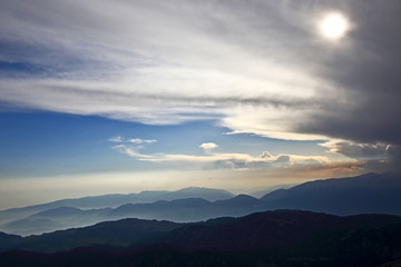 Fototapeta premium sunset in the clouds on a mountain background