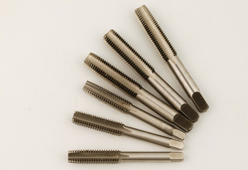 Cutting tool to make thread known as hand tap on white background