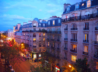 Paris, night city landscape. Stylish beautiful houses make an architectural complex of the city street. Montmartre district, Paris, France