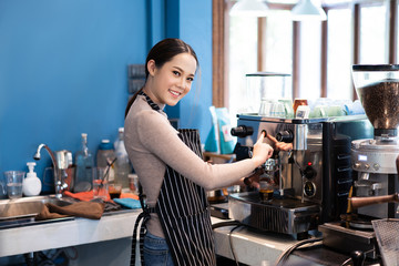 Barista asian woman are making coffee in a store owned by a business.