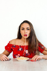 beautiful young woman eating pasta portrait