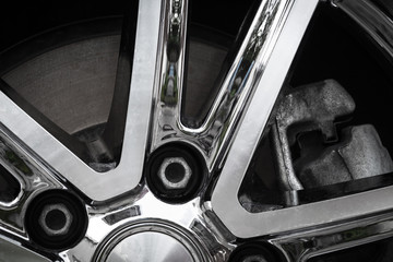 Chrome modern car wheel close-up after washing.
