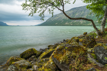 Fototapeta na wymiar Mountain lake with beautiful clean green water.