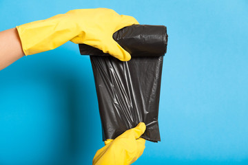 Plastic garbage bag, black roll, bin chores. Disposable polyethylene waste trash.
