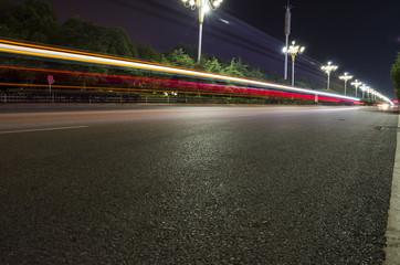 Empty asphalt road and modern skyline at night