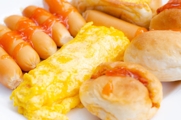 First  Breakfast with Sausage, bread,egg on white plate in the morning time,close-up view.