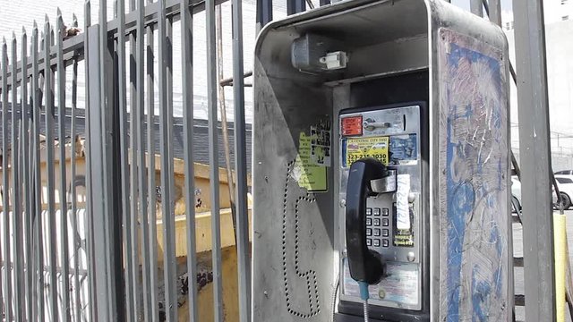 Old Pay Phone in Los Angeles by fence
