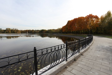 Walk along the pond in the autumn park