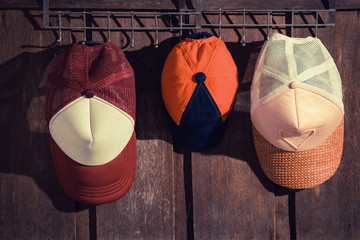 family hat hanging on the wooden wall