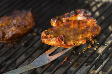 Beef steaks on charcoal grill