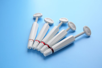 Syringes of resin luting cement on color background