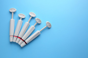 Syringes of resin luting cement on color background