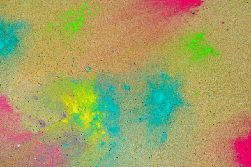 Holi paint on sea sand