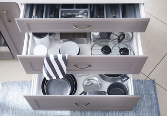 Set of clean kitchenware in drawers