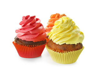 Delicious colorful cupcakes on white background