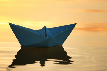 Origami boat on water surface