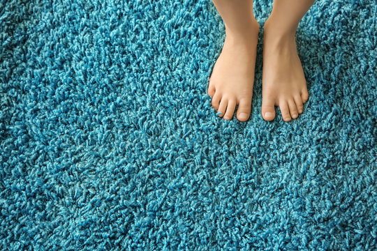 Barefoot girl standing on carpet - Powered by Adobe