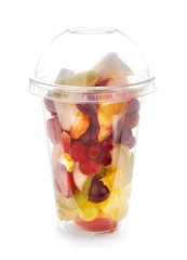 Plastic cup with delicious fruit salad on white background