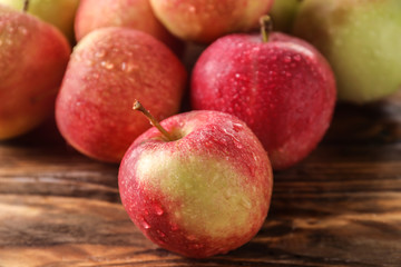 Ripe juicy apples on wooden table