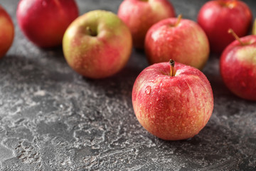Ripe juicy apples on grey table