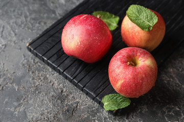 Ripe juicy apples on wooden board