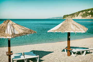 Beach umbrellas and sun beds on the ocean