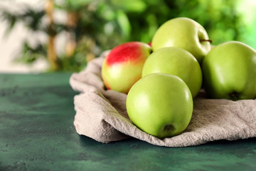 Ripe fresh apples on color table