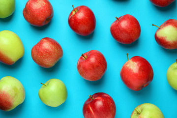 Different ripe fresh apples on color background