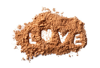 Cacao powder with word LOVE on white background