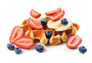 Delicious waffle with berries and banana on white background