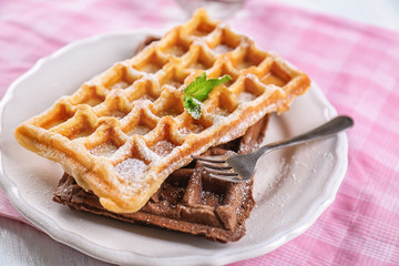Delicious waffles with sugar powder on plate