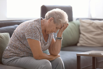 Depressed elderly woman at home