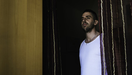 Attractive young man with beard seen from below