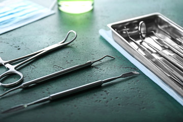 Dentist's tools with tray on color table