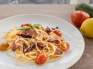 Image of temptation dish, new fusion food  Italian style with Thai taste. Spaghetti spicy bacon cook with hot dry chili sauce. Food design for who love hot and spicy taste.