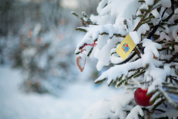 New Jersey state flag. Christmas background outdoor. Christmas tree covered with snow and decorations and New Jersey flag.  New Year / Christmas holiday greeting card.