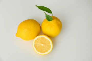 Ripe juicy lemons on white background