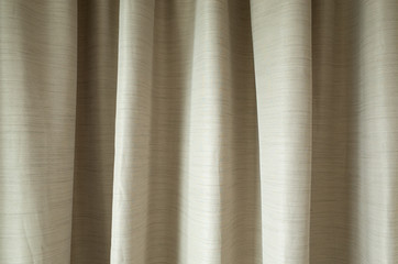 beige  fabric curtains in bedroom; interior design concept.