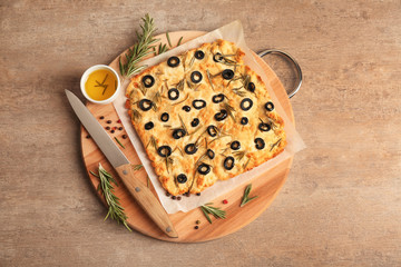 Traditional Italian Focaccia with rosemary on light table